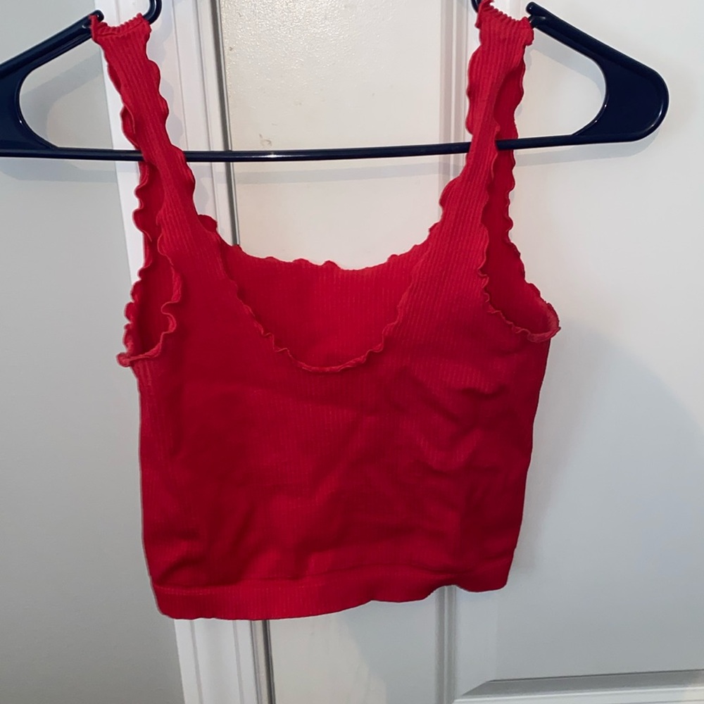 Cropped tank top with ruffled design along sleeves and neckline